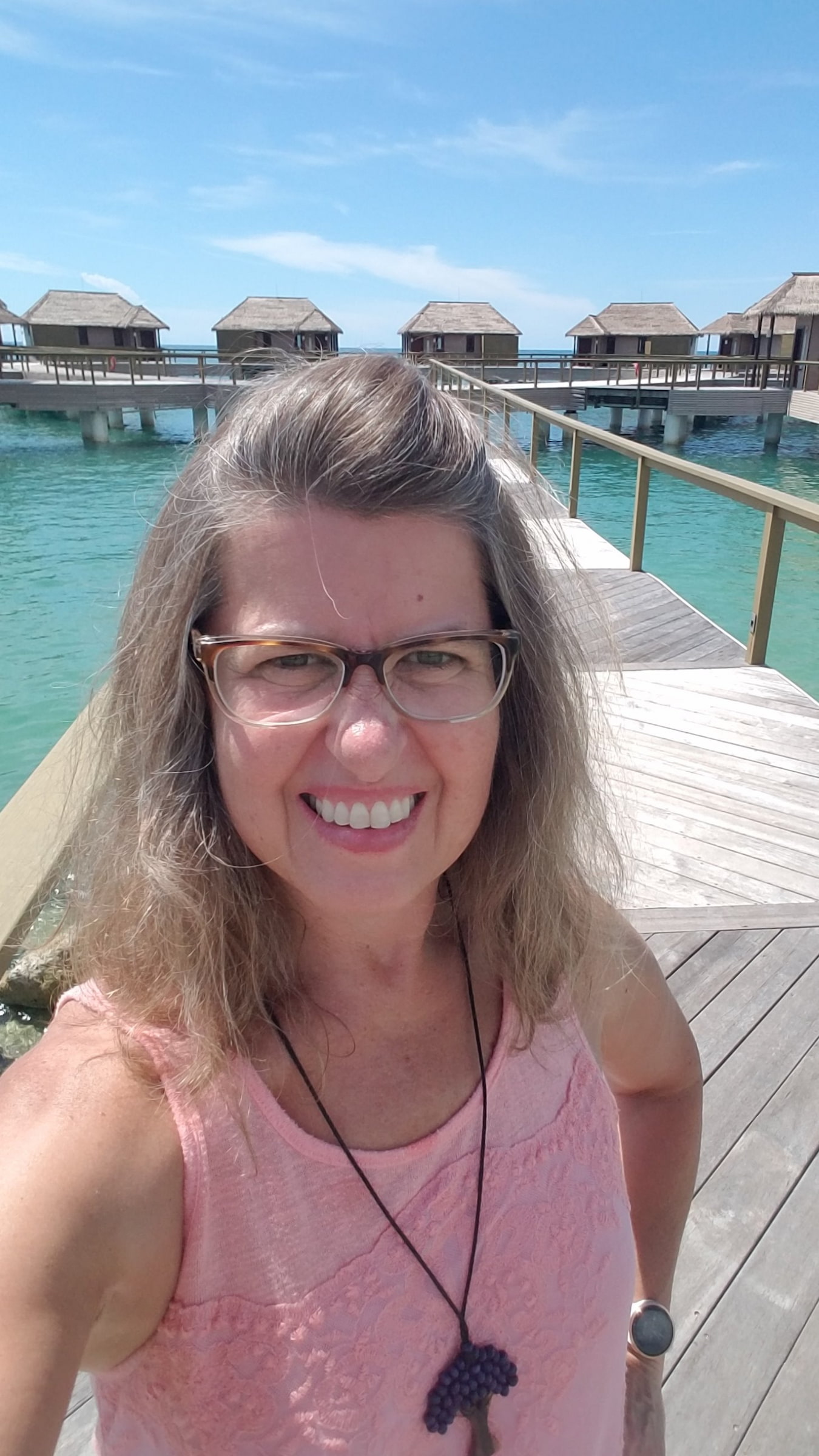 Overwater Bungalows Sandals South Coast Overwater bungalows at Sandals South Coast in Jamaica with guest walking on the boardwalk